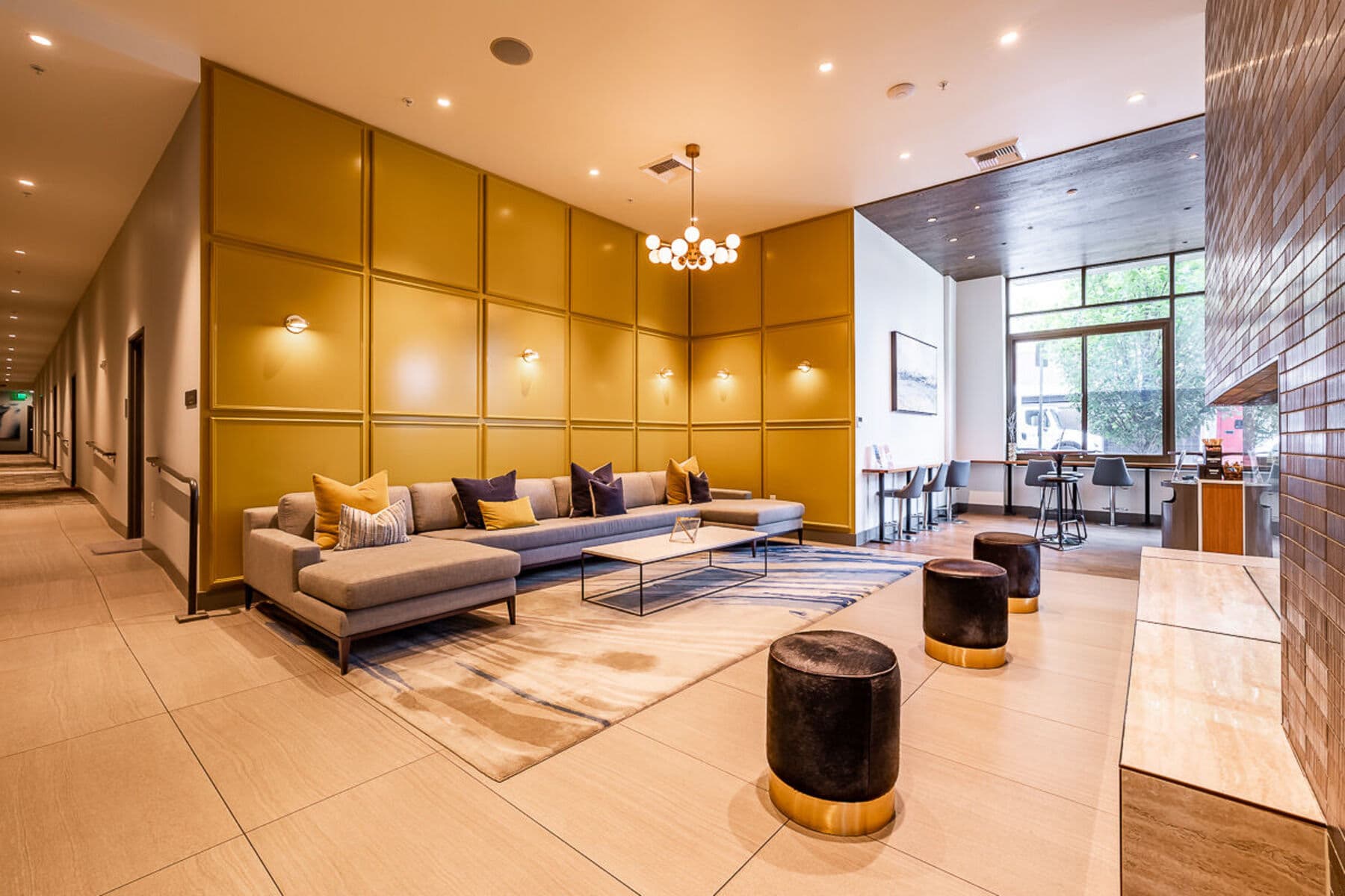 Elara at the Market — lobby lounge with gold-paneled feature wall